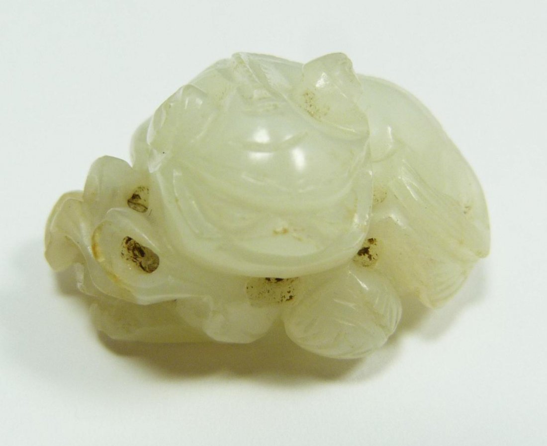 CHINESE CARVED TRANSLUCENT JADE FOO DOG TOGGLE: Chinese carved translucent white jade foo lion toggle. Exquisite translucent white jade. Measures 1" height x 1 3/8" width (2.5cm x 3.5cm). Total weight of 22 grams.