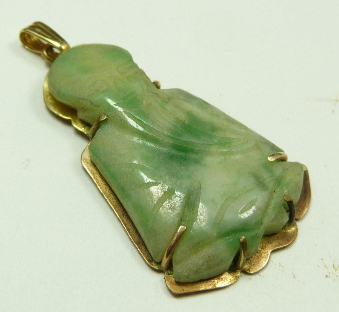 14K YELLOW GOLD MOUNTED JADE PENDANT: A 14k yellow gold mounted Chinese jade pendant depicting a seated wiseman with long beard. White to emerald and apple green jade colors. Marked 14K to verso of mount. Measures 1 3/4" length x 1" width