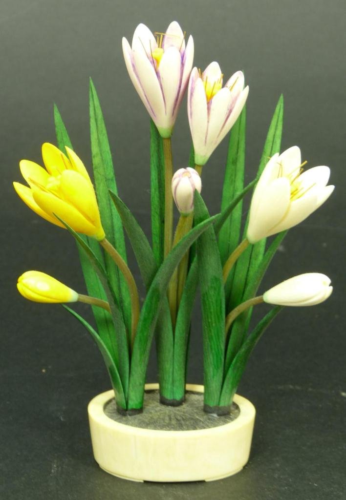 CHINESE CARVED IVORY POLYCHROMED FLOWER GROUP: A Chinese hand carved and polychromed ivory flower group in pot. Measures 5 1/8" height (13.1cm). Total weight of 57 grams.