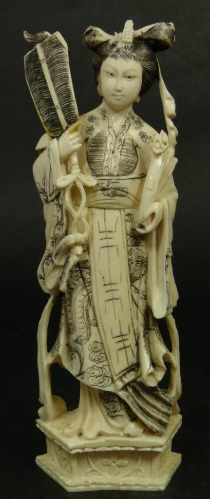 CHINESE CARVED IVORY QUAN YIN SCULPTURE: Chinese Quan Yin carved ivory figure depicted holding a fan and Ruyi Scepter, and standing on stylized Lotus Blossom base. Measures 6 5/8in Height. Weighs 162g.