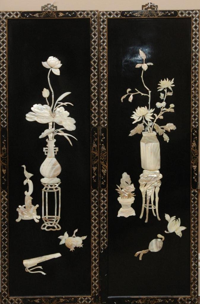 PR. CHINESE M.O.P. APPLIQUE LACQUER WALL PLAQUES: Pair of Chinese black lacquer wooden wall plaques having inlaid Mother of Pearl floral scenes with vases and stands. 19th/20th century. Each measures approx. 37in Height x 12.25in Width.