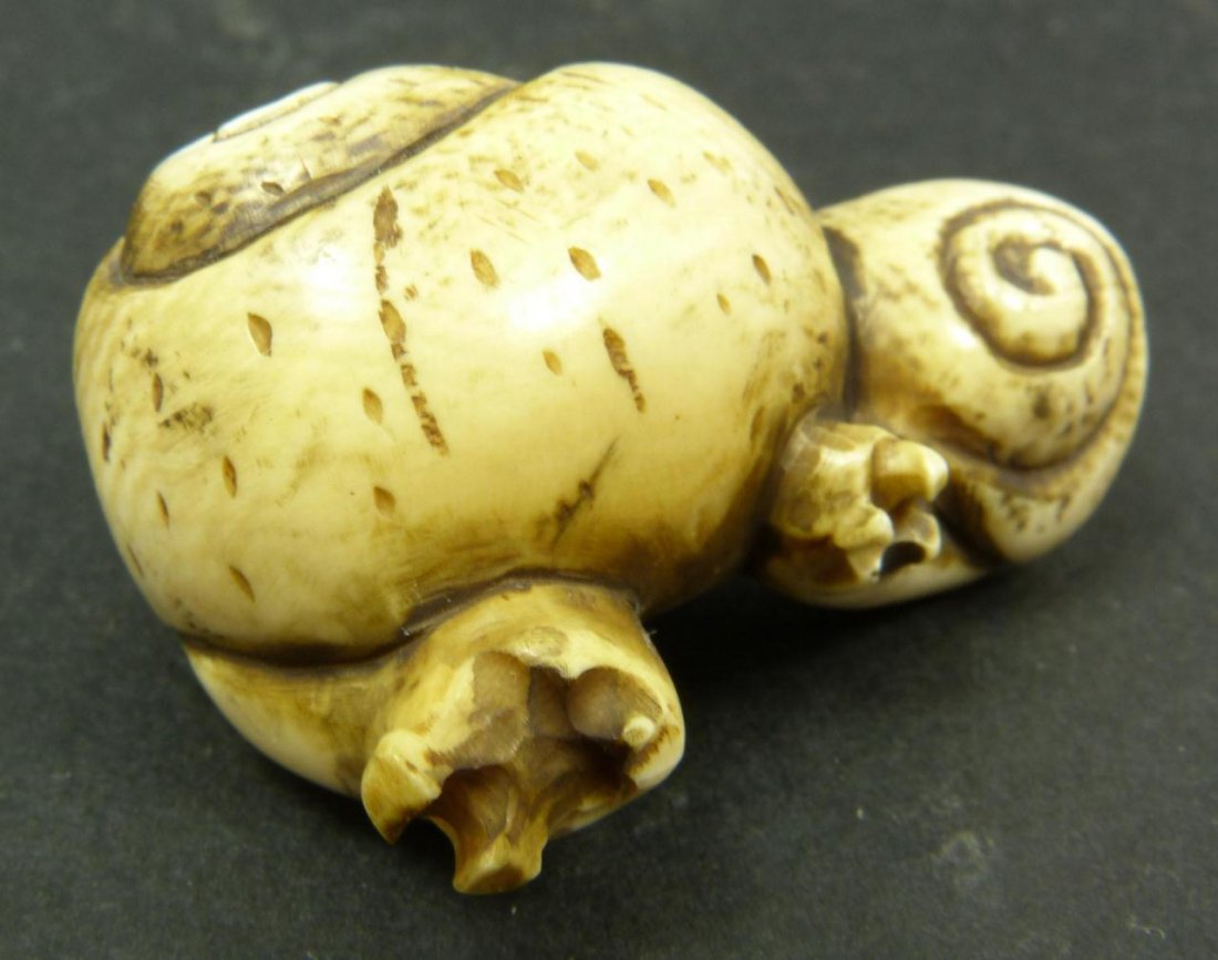 JAPANESE IVORY SIGNED NETSUKE SNAIL GROUP: Japanese hand carved ivory Netsuke group depicting two snails. Etched calligraphy signature to bottom. Measures 1 1/8in Height x 1 7/8in Width. Weighs 23g.