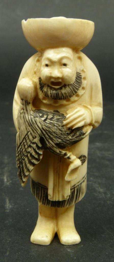 JAPANESE CARVED IVORY NETSUKE MAN WITH DUCK: Japanese carved ivory Netsuke figure depicting man holding duck. Etched calligraphy signature to bottom. Measures 2 5/8in Height. Weighs 23g.