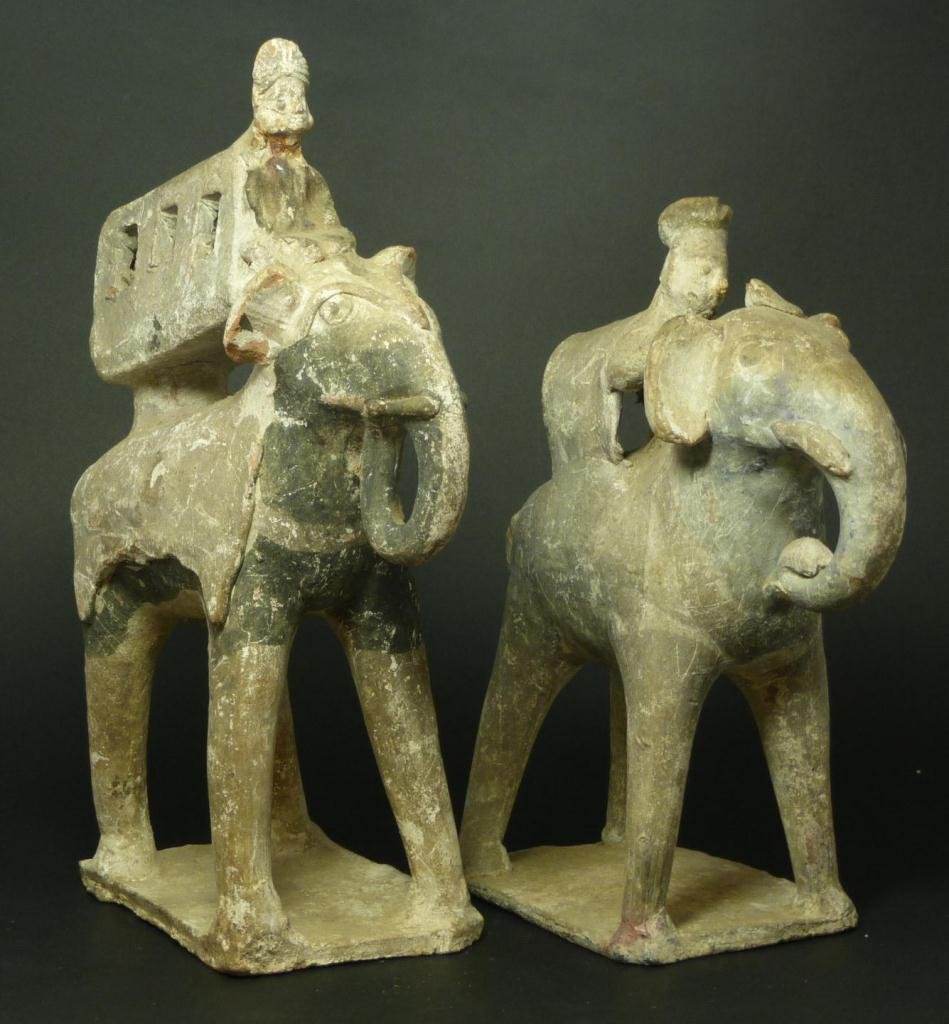 PAIR OF ASIAN ELEPHANT RIDER POTTERY ROOF TILES: A pair of Asian figural roof tiles depicting people on elephant back. Tallest measures 11 3/4" height (29.8cm). Total weight of 2390 grams.