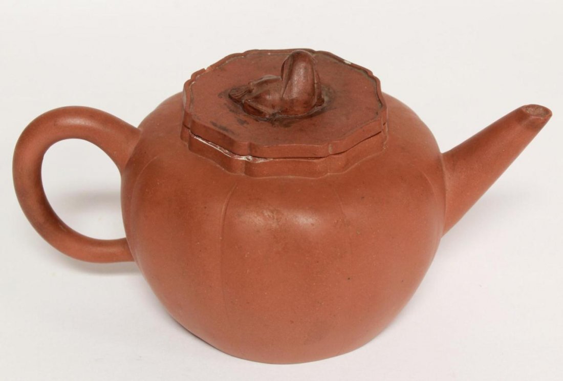 CHINESE RED TERRACOTTA POTTERY FOO LION TEAPOT: Chinese red terracotta pottery teapot with figural foo lion finial tea cover. Bottom holds impressed calligraphy marks. 19th/20th century. Measures 4.5in H Weighs 478g