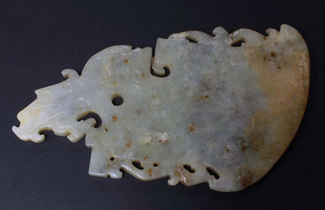 CHINESE CARVED JADE FIGURAL AXE BLADE PLAQUE: Chinese carved pale green - honey Jade axe blade plaque. Highly translucent piece carved with human and dragon motif. Measures 6 1/4" (15.87cm). Total weight approx. 186 grams.