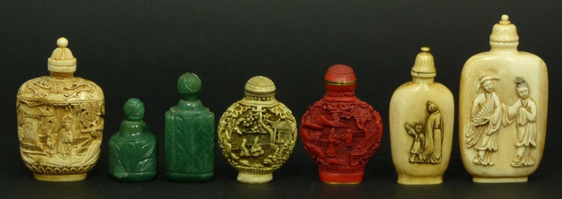 A LOT OF 7 CHINESE CARVED SNUFF BOTTLES: A lot of seven Chinese hand carved ivory snuff bottles having relief and etched designs including three ivory, two of green quartz, and lastly a faux ivory and faux cinnabar. 19th/20th century. Larges