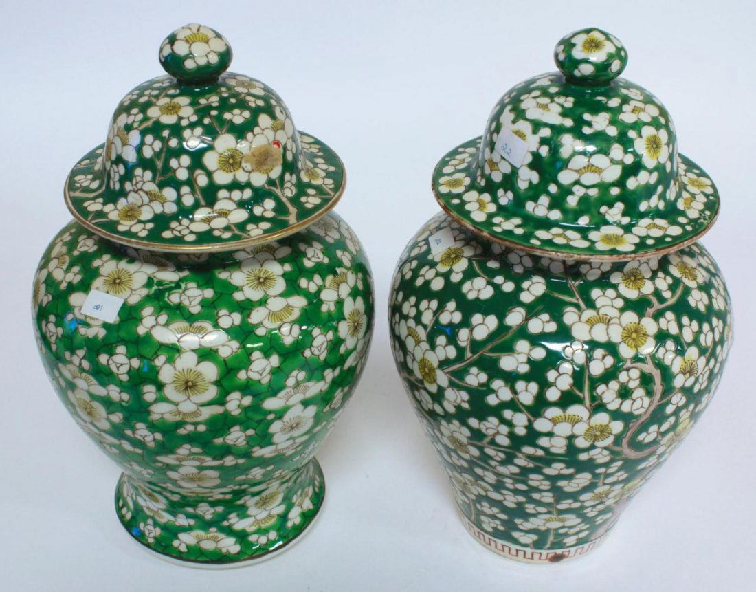 PAIR OF CHINESE GREEN LIDDED GINGER JARS: A pair of antique Chinese covered baluster form ginger jars depicting white flowers over green ground. Mid to late Qing Dynasty period, 19th century. Each measures approx. 105/8in Height. Weighs 3215g