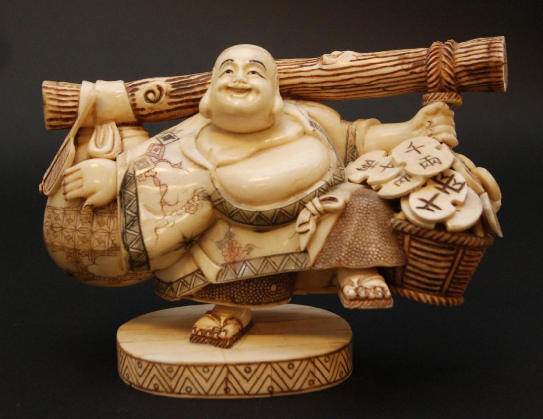 CHINESE CARVED OX BONE HOTIE BUDDHA: Chinese carved ox bone standing Buddha figure on one leg balancing with log to back holding sack and coins. late Qing Dynasty to Republic Period.6 5/8in Height x 9in Width. Weighs 1055 grams.