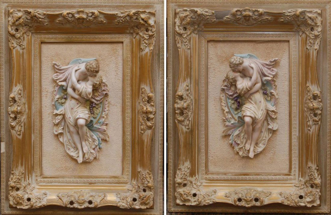 A PAIR OF CONTINENTAL BISQUE FIGURAL WALL PLAQUES: A pair of antique Continental bisque porcelain wall plaques depicting a man and woman kissing. Mounted to wooden frames on matted panel. Each measures approx. 12 1/2" height (31.7cm). Overall measurem