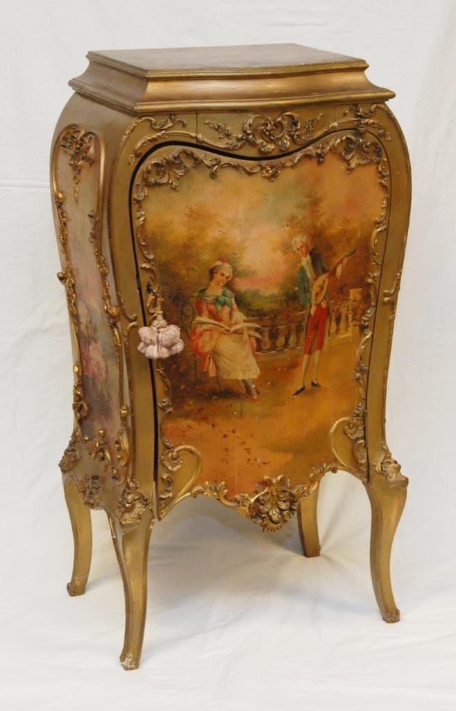 19th CENTURY GOLD GILT HAND PAINTED FRENCH COMMODE: An antique hand painted gilt painted French commode having courting couple scene to front. Front opens with hinged design and locking mechanism. Interior having five shelves. Verso holds old Shellas &