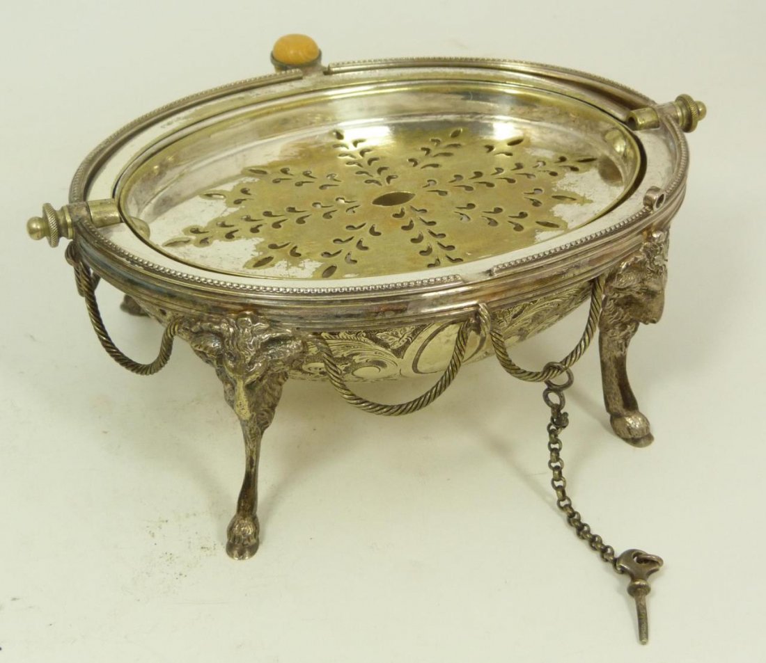 ANTIQUE VICTORIAN SILVERPLATE GOATS BUTTER DISH: Antique European silver plate hinged covered egg shape footed butter dish. Chased scrolled design to cover. Figural goat head and hoof four foot design. Ivory handle. Has chain attached locking pin. 1