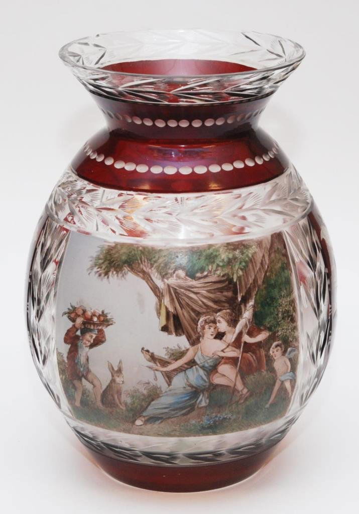 BOHEMIAN INTAGLO CUT GLASS VASE PAINTED BY WURTIG: Bohemian intaglio ruby to clear cut art glass vase having hand painted scene depicting a courting couple with cherubs and rabbit. Signed K Wurtig to lower left. Measures 12" height x 9 1/2" diameter (