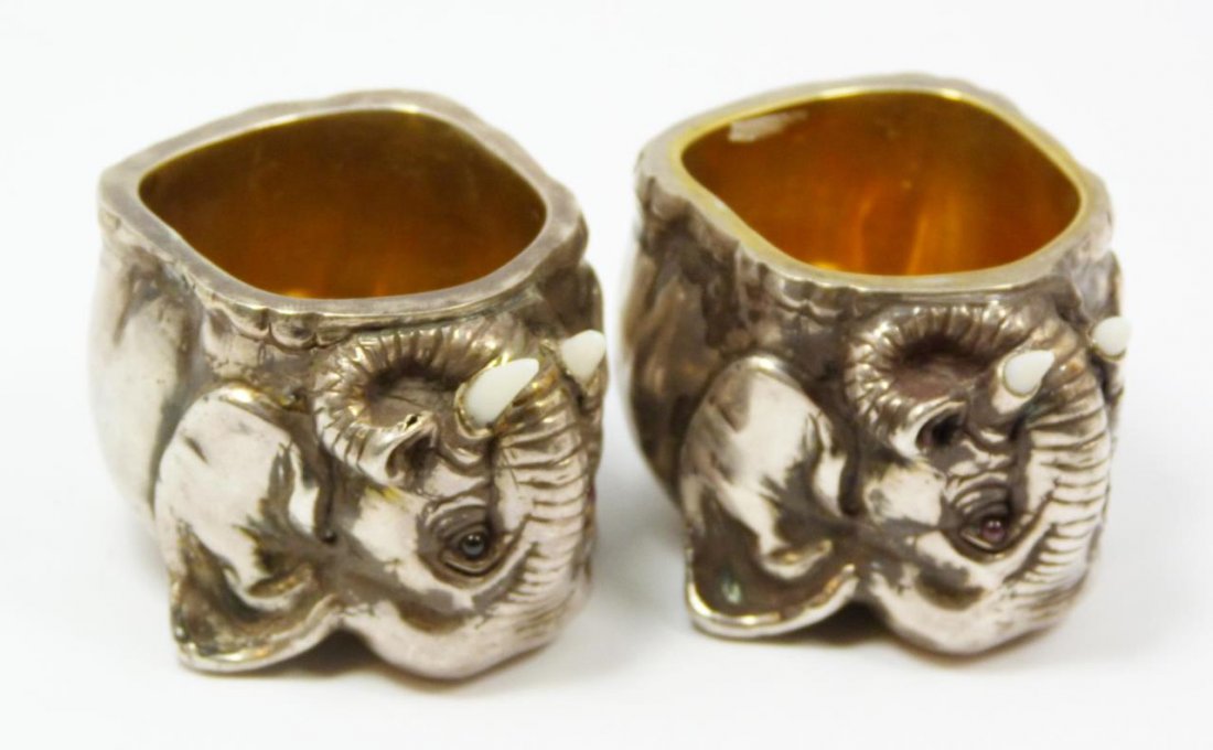 Pr RUSSIAN SILVER ELEPHANT SALT CELLARS: 2 Russian silver standing elephant figural salt cellars with cabochon cut pink sapphire stones set in eyes. Carved ivory tusks. Each holds town, 84 silver purity and Julius Rappoport "I.P." workmaster