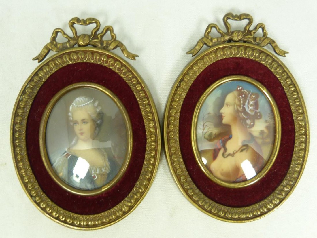 PAIR OF FRENCH OIL PAINTINGS ON OVAL PLAQUES: Pair of antique French hand painted oil on celluloid plaques depicting miniature portraits of women. One signed 'HiL'. Both mounted in bronze frames with stylized laurel leaf border and ribbon top. La