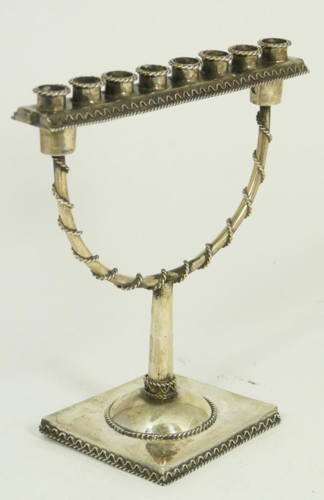 RUSSIAN JUDAIC SILVER MENORAH: A Russian Judaic silver menorah with twisted wire overlay design. Removable 8 candle holder insert converting it to two arms. Base holds workmaster marks, BC/1873 assayer marks, 84 silver purity and t