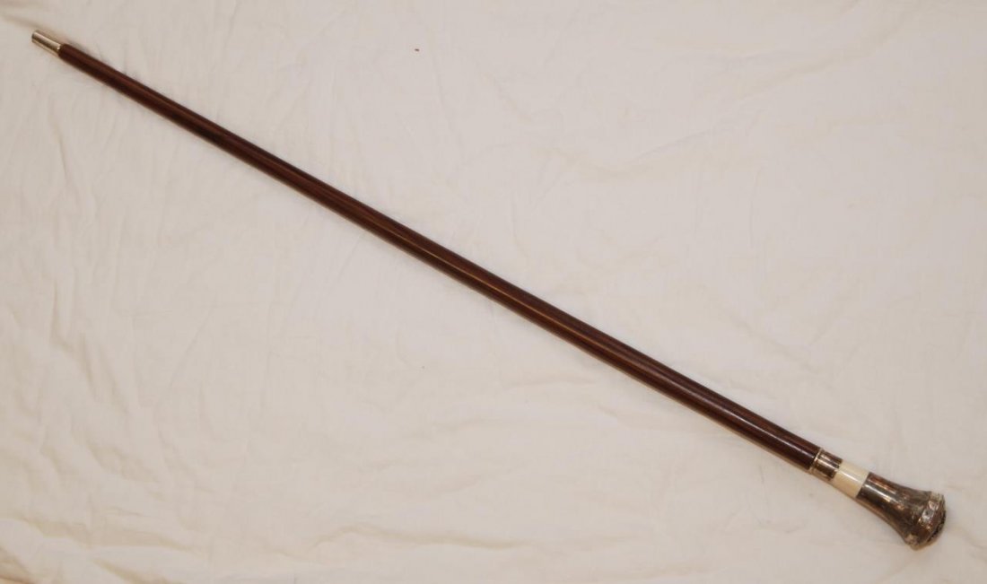 RUSSIAN SILVER AND IVORY POCKET WATCH CANE: Russian silver cane having hinged cover to handled housing a pocket watch. Applique double headed eagle to top handle one inch leather band to handle. Marks to side of handle and heel. Measures 36in (