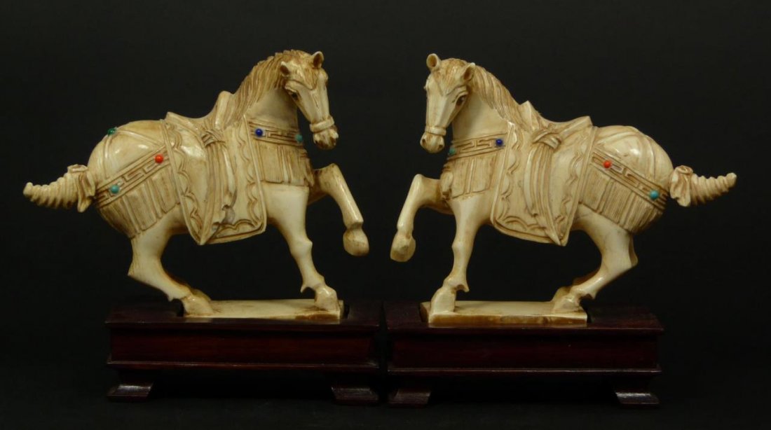 Pr CHINESE CARVED AFRICAN IVORY HORSE FIGURES: Pair of Chinese hand carved African ivory figures depicting horses with front leg up and wearing imperial blanket saddle and tack. Adorned with cobalt, coral and turquoise enamel bead design. Includes