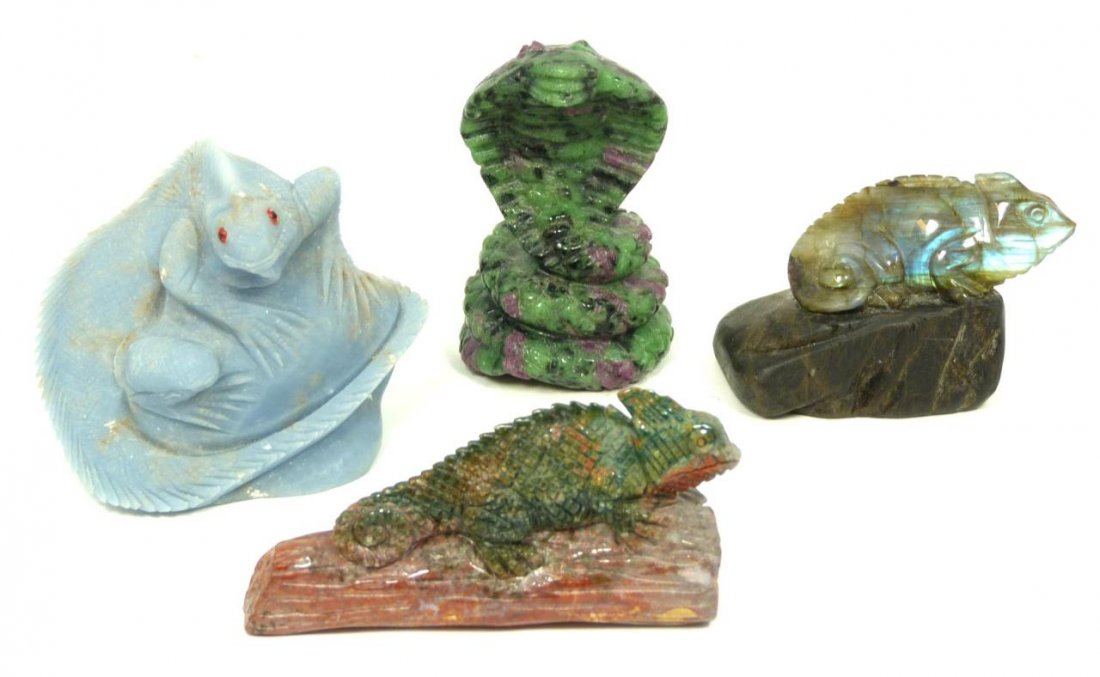 4 CARVED STONE REPTILE ANIMAL FIGURES: A lot of four hand carved stone animal figures including a labradorite and bloostone agate chameleons, zoisite coiled cobra and a blue stone iguana. Tallest measures 2 7/8" height (2.8cm). Total weigh