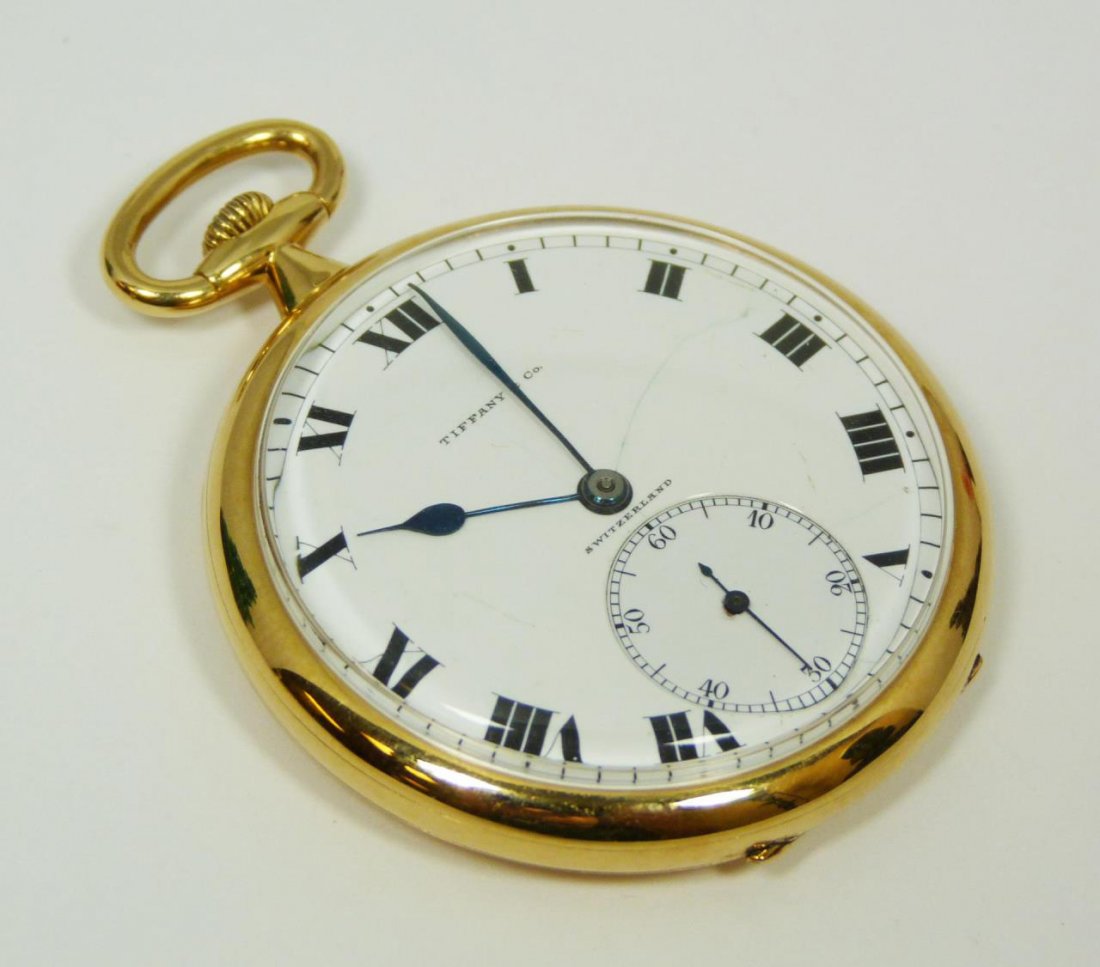18K YG AGISSIZ POCKET WATCH FOR TIFFANY & CO: Beautiful 18k yellow gold Agassiz, Swiss watch made for Tiffany & Company. Open face design with white enamel. Black Roman Numerals and notches. Metallic cobalt hour, minute and sub second hands. 21 J