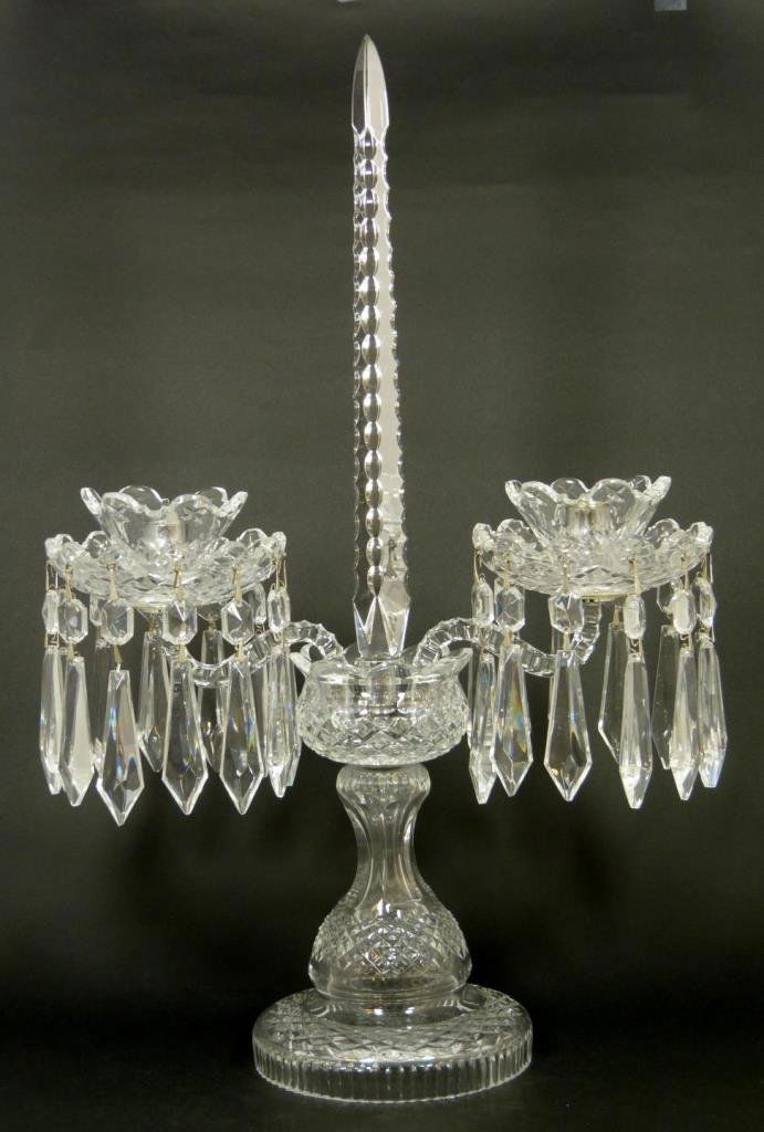 WATERFORD CUT CRYSTAL TWO ARM CANDELABRUM: Waterford cut crystal candelabrum having a two branch design with three sided obelisk to center. Cut diamond matrix patterns throughout. Measures 20" height x 13" width (50.8cm x 33cm). Total weight o
