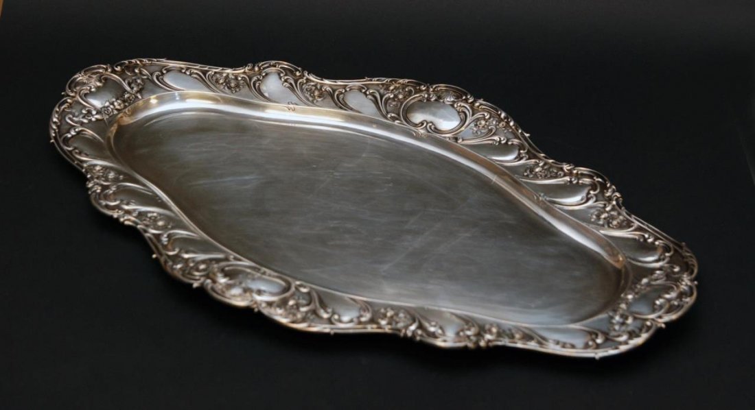 GORHAM STERLING SILVER 22" OVAL SERVING TRAY: Reed and Barton American sterling silver oval serving tray having a repousse floral scroll design to rim. Bottom holds 'Lion Anchor G' mark and numbered A588. Measures 22 1/2" length (57.15cm). Total 