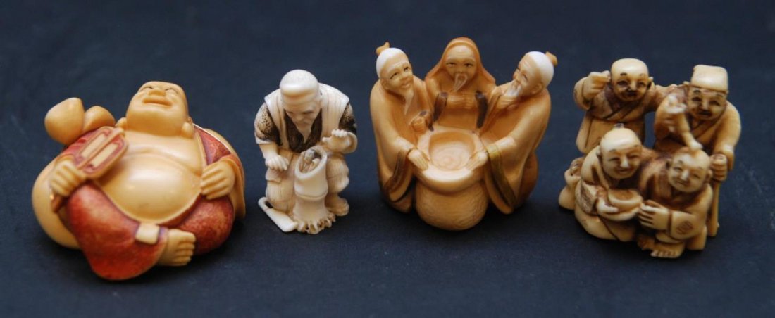 LOT OF 4 JAPANESE CARVED IVORY NETSUKE FIGURES: A lot of four Japanese carved African ivory netsuke figures including a man with oni demon in bamboo, three men surrounding a pot, a group figure of wisemen and reclining Hotei Buddha with wrapped gol