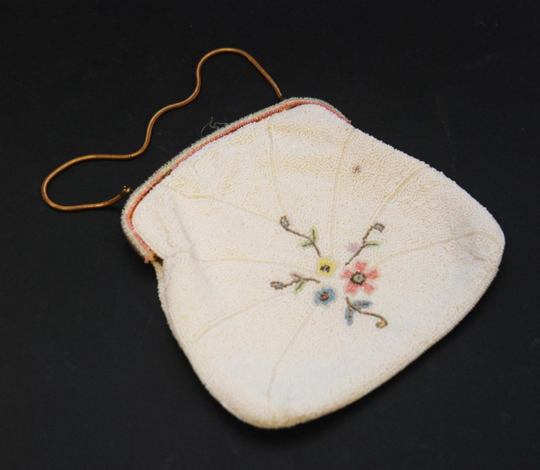 OLD FRENCH MICRO BEAD FLORAL PURSE: Vintage French hand made micro bead purse having a floral design thorughout with white ground. Cream silk interior with label 'HAND MADE IN FRANCE'. Gold tone frame. Gold tone strap with 5" drop (12.7