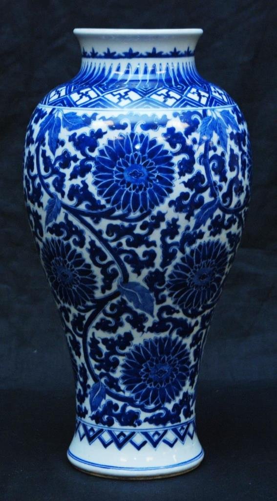 CHINESE HAND PAINTED BLUE & WHITE MEI PING VASE: A Chinese Qing Dynasty period hand painted blue and white mei ping form vase. Depicts lotus blossoms with scrolled vines with leaves. Bottom holds blue six character calligraphy Qing reign mark with r