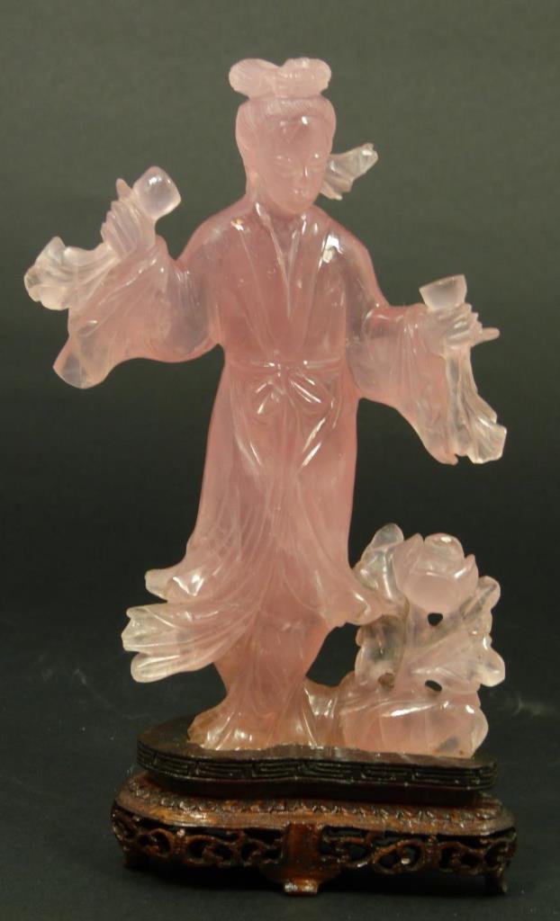 CHINESE CARVED ROSE QUARTZ QUAN YIN FIGURE: Chinese hand carved rose quartz sculpture depicting a standing Guan yin near flowers and holding cups. Includes fitted wooden base and presentation box. Measures 6 1/8" height + 1 1/8" base height (15
