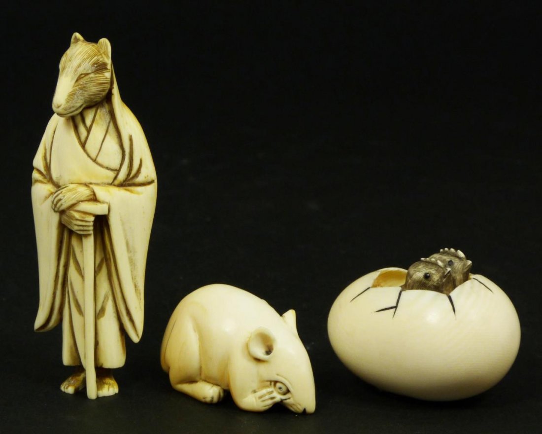LOT OF THREE JAPANESE CARVED AFRICAN IVORY NETSUKE: A lot of three Japanese carved African ivory netsuke. Includes a signed egg with two moving chicks, recumbent rat, and figural rat in kimono and holding cane. Etched calligraphy signature to verso. 19