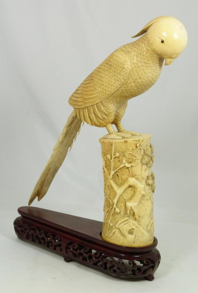 ANTIQUE CHINESE CARVED AFRICAN IVORY BIRD FIGURE: Antique Chinese relief carved African ivory bird sculpture. Depicts bird on cylindrical landscape scene perch. Includes fitted wooden base. Bottom holds four character etched calligraphy reign mark. L