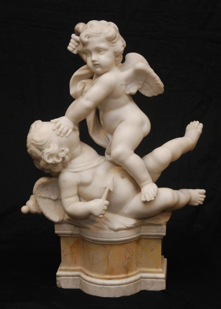 CONTINENTAL ALABASTER & MARBLE CHERUB FIGHT SCEN: A European carved alabaster and marble carving depicting two winged putti fighting. 20th century. Measures 24" height x 18" width (60.9cm x 45.7cm).