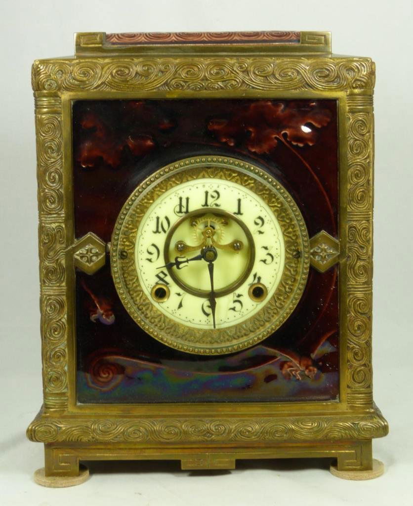 NEW HAVEN BRONZE MANTLE CLOCK J. & J. G. LOW TILE: Antique New Haven Clock Company bronze mantle clock decorated with J. J. & G. Low glazed earthenware tiles to sides face and top. Bronze case and applied tiles each having a matching scrolled 'wind' d