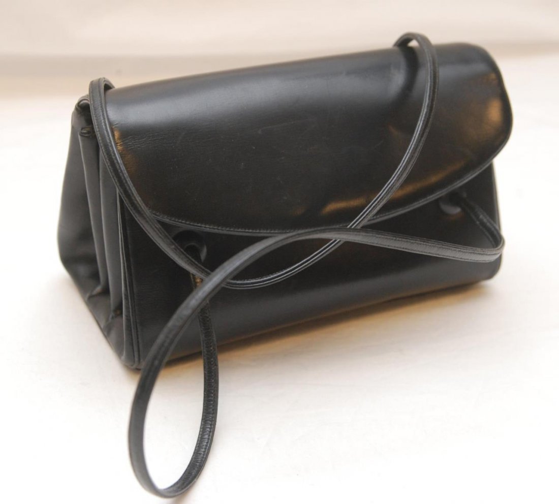 JUDITH LEIBER BLACK LEATHER BAG: Judith Leiber black leather bag having a double interior & flap design. Black silk interior. Measures 5" height x 8" width x 4 1/4" depth (12.7cm x 20.3cm x 10.7cm).