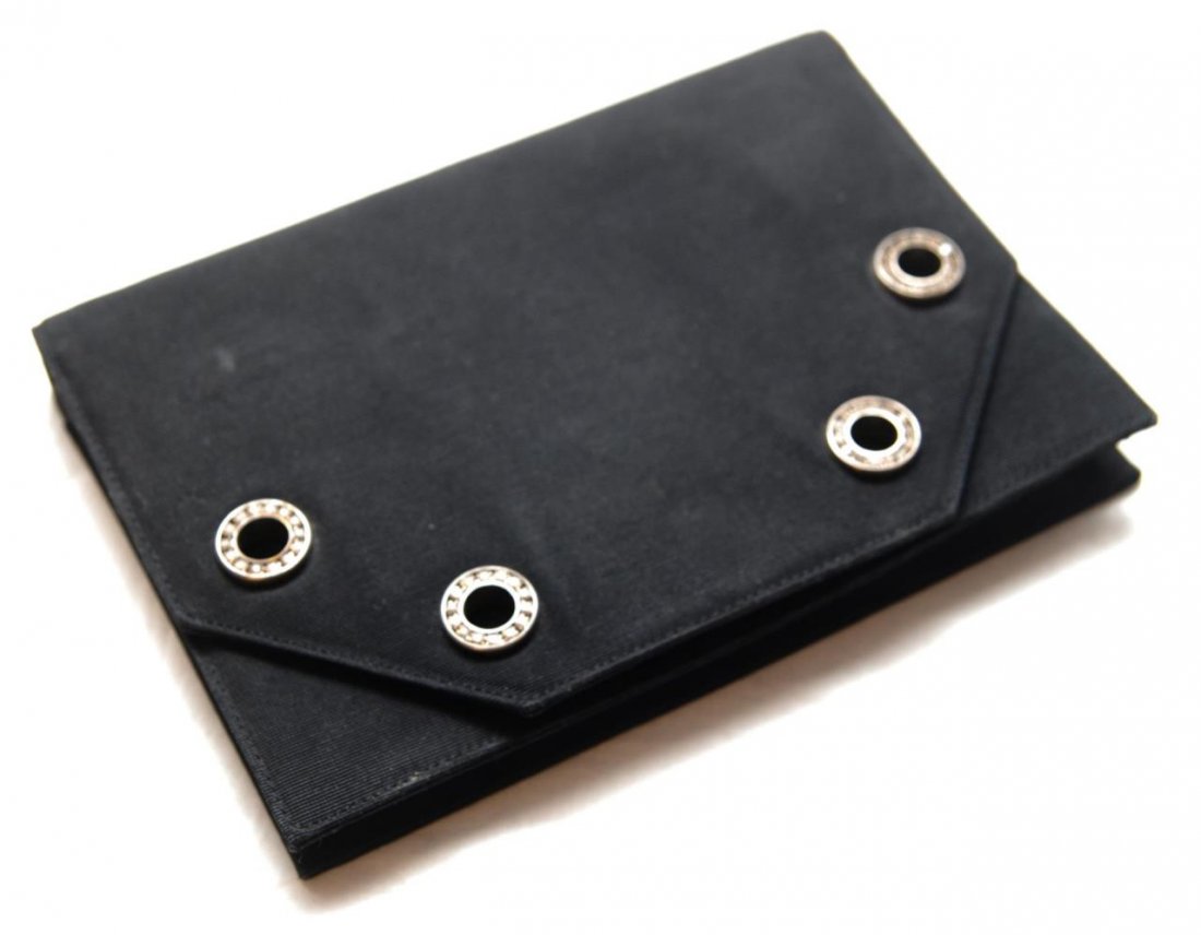 VALENTINO GALAVERI ITALY BLACK PURSE: Valentino Galaveri black folding purse having round rhinestone bezel design to front. Red interior with one zippered pocket. Detachable chrome color chain strap with rhinestone links. Measures 5" heig