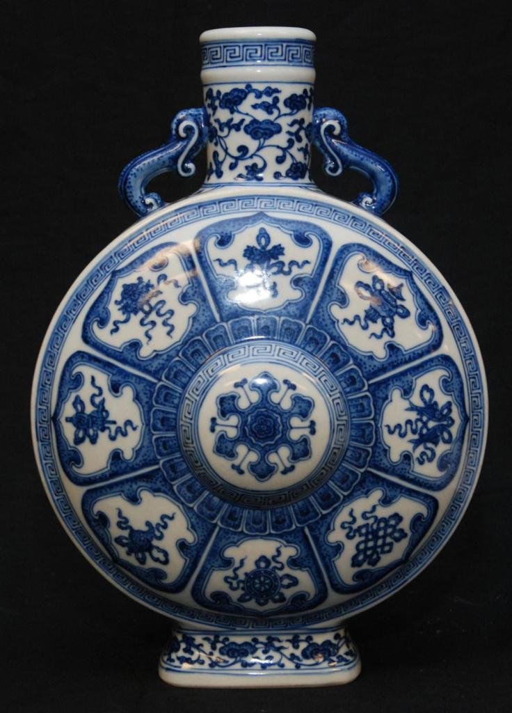 CHINESE QING BLUE & WHITE PORCELAIN FLASK VASE: Antique Chinese Qing Dynasty hand painted blue and white porcelain flask vase depicting a floral design throughout with protruding nipple on front and back. Figural lingzhi root handles. Holds Qianlon