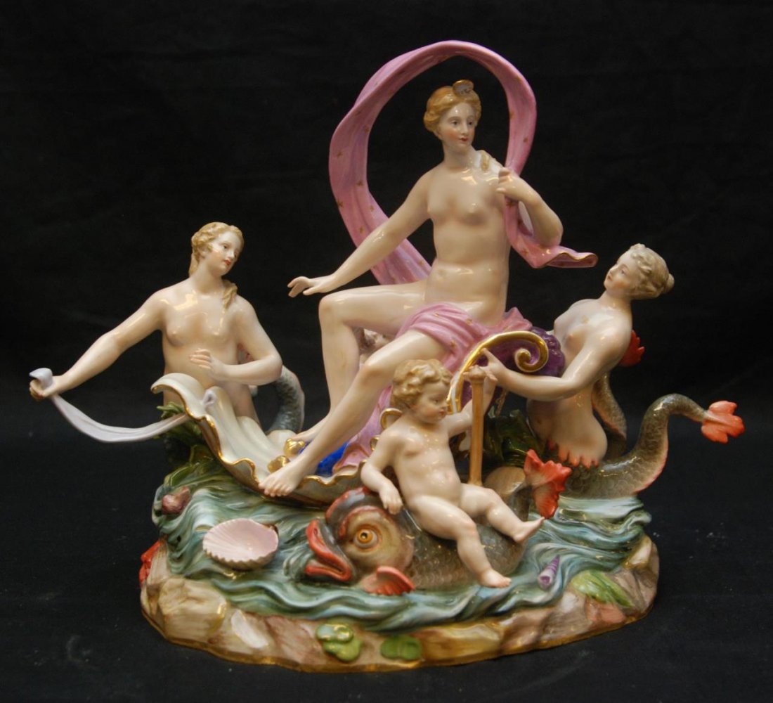 MEISSEN PORCELAIN GROUP OF VENUS AND ATTENDANTS: Centered by Venus seated in a shell chariot riding a wave, surrounded by attendants in the form of putti, dolphins and mermaids, underglaze blue crossed swords with single cancellation, incised D81, i