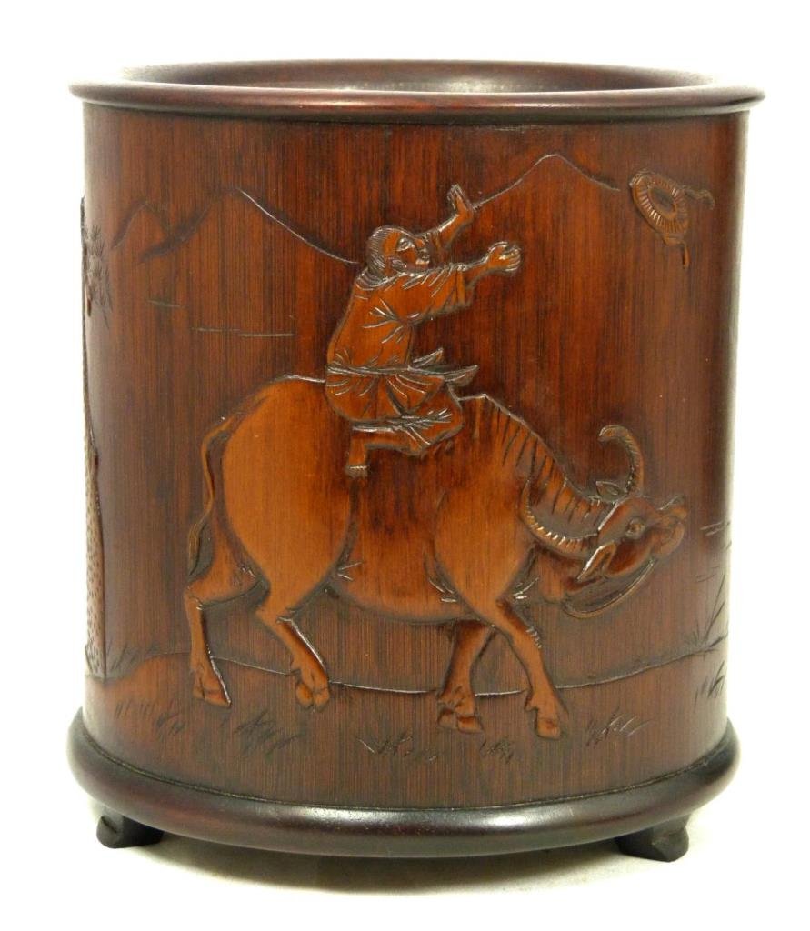 18th C CHINESE BAMBOO & ZITAN WOOD BRUSH POT: Antique Chinese carved brush pot having a bamboo body with finely raised scene with man on ox. Verso depicts etched calligraphy. Tripod Zitan wood base attached to bottom. Measures 5 3/4" height x 5 1