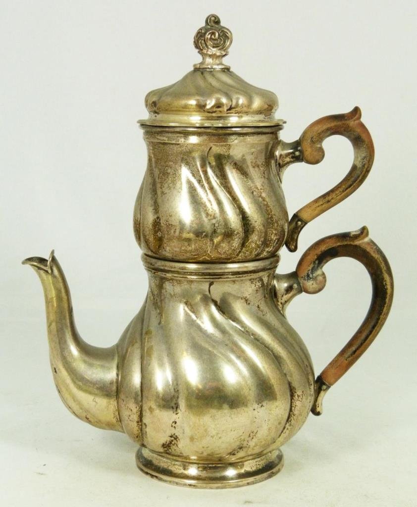 HERMANN BEHRND GERMAN 800 SILVER STRAINING TEAPOT: Antique Hermann Behrnd German 800 tea pot having an optional strainer design with additional straining insert. Each having carved wooden handles and scrolled bodies. Circa late 19th to early 20th cent
