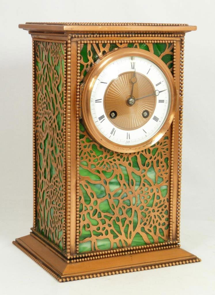 RIVIERE STUDIOS GRAPEVINE SLAG CLOCK H&H FRANCE: Old Riviere Studios clock having a reticulated grapevine pattern design with green slag glass backing to copper case. Mechanical movement marked 'H & H' and numbered 6459. Also marked 'MADE IN FRANCE