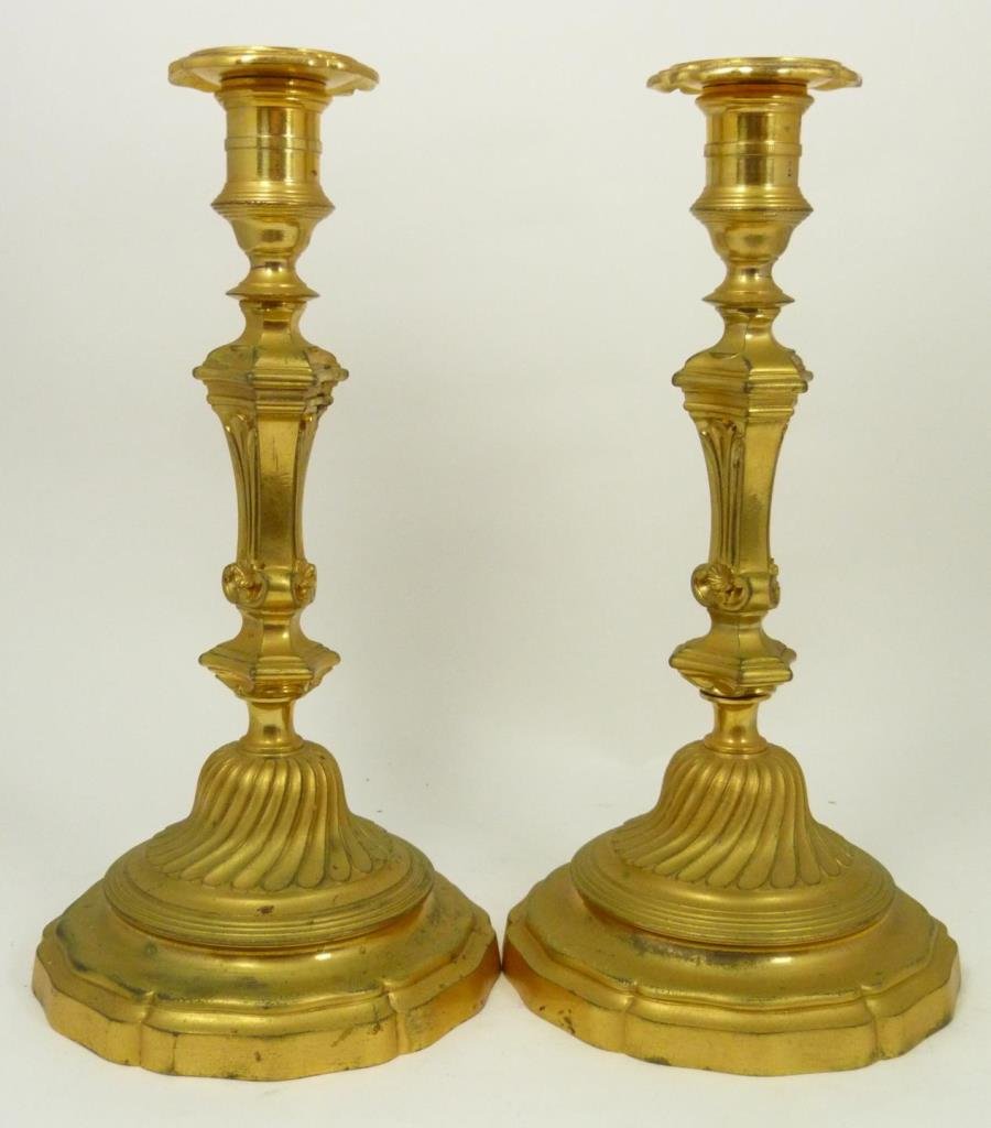 Pr CHRISTOFLE FRANCE GILT METAL CANDLESITCKS: A pair of French gilt brass candlesticks by Christofle, Paris. First half of the 20th century. Each stamped Christofle with C scale C mark. One numbered 289037 and the other 289040. Each measures appr