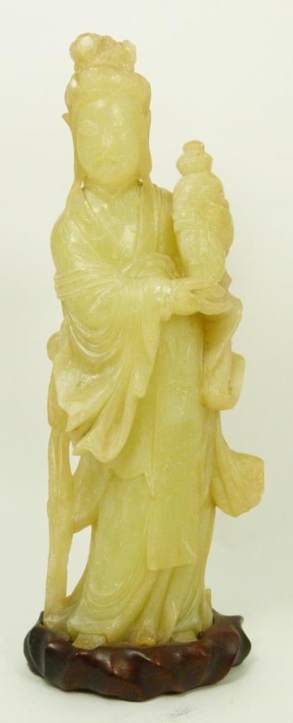 ANTIQUE CHINESE SOAPSTONE MAIDEN SCULPTURE: Antique Chinese hand carved pale green translucent soapstone sculpture depicting a standing maiden holding a vase. Includes fitted wooden base. Qing to Republic period. Measures 11 5/8" height + 1" ba