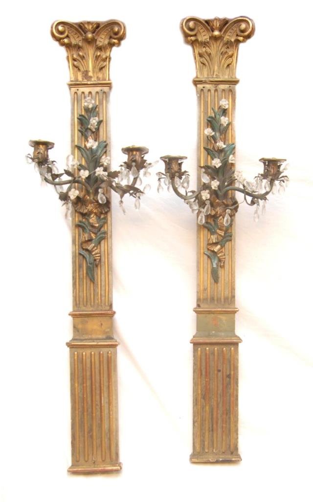 PAIR OF WOOD, PORCELAIN & CRYSTAL WALL SCONCES: A pair of European hand carved and painted wooden pan sconces with gilded bronze and porcelain arms having crystal prisms. Circa 19th to early 20th century. Each measures approx. 40" height x 13" widt