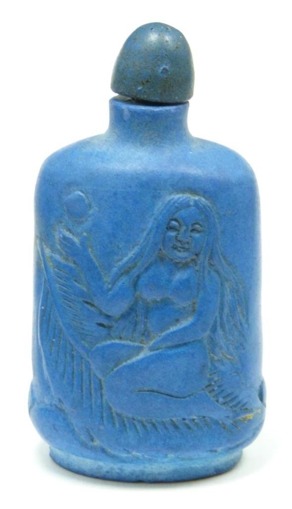 CARVED SODALITE FIGURAL SNUFF BOTTLE: Depicting a nude figure on one side and palm tree on the other. Measures 3 1/4" (8 cm) height. 104.7 grams.