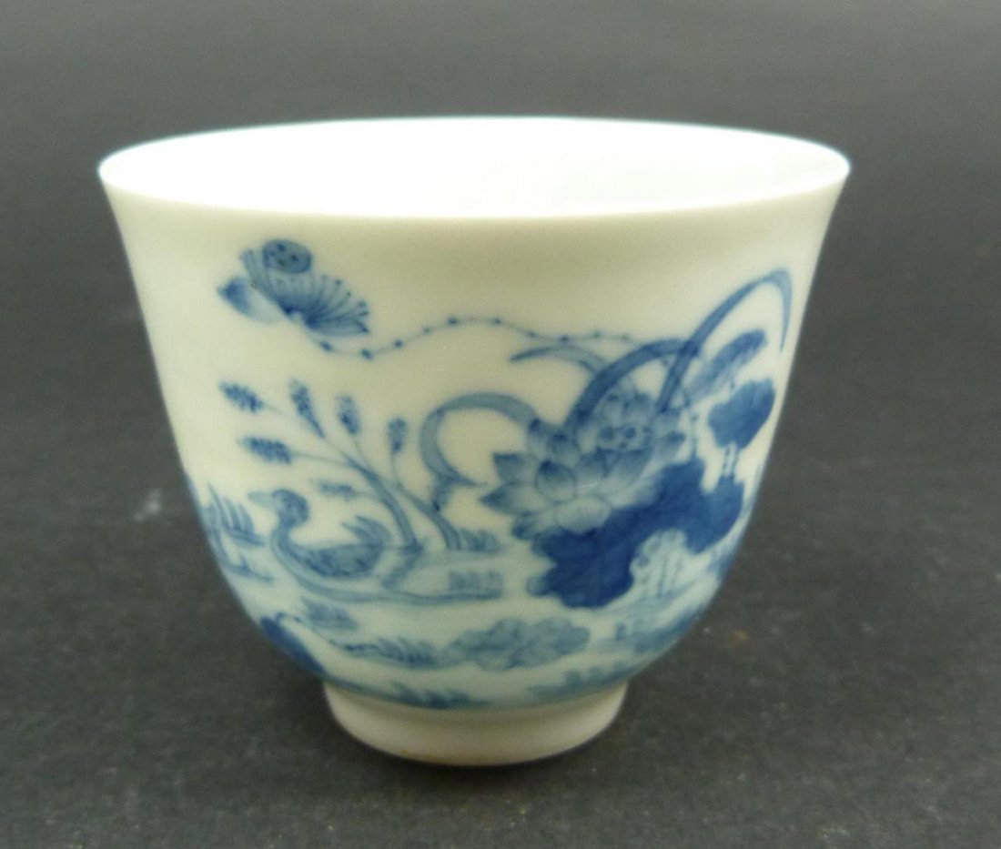 18th C CHINESE BLUE & WHITE CALLIGRAPHY CUP: Antique Chinese hand painted blue and white calligraphy egg shell porcelain cup. Also depicts landscape scene with ducks. Bottom holds blue six character Kangxi (1662-1722) reign mark, and is of the p