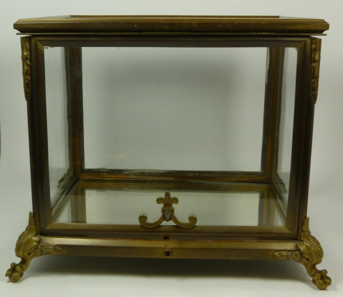 ANTIQUE BACCARAT GILT METAL FOOTED CURIO BOX: Antique Baccarat French Gilt metal curio or Tantalus box having glass screen design. Hinged front and top open and lock. Locking mechanism to front. 19th century. Impressed Baccarat mark to metal bott