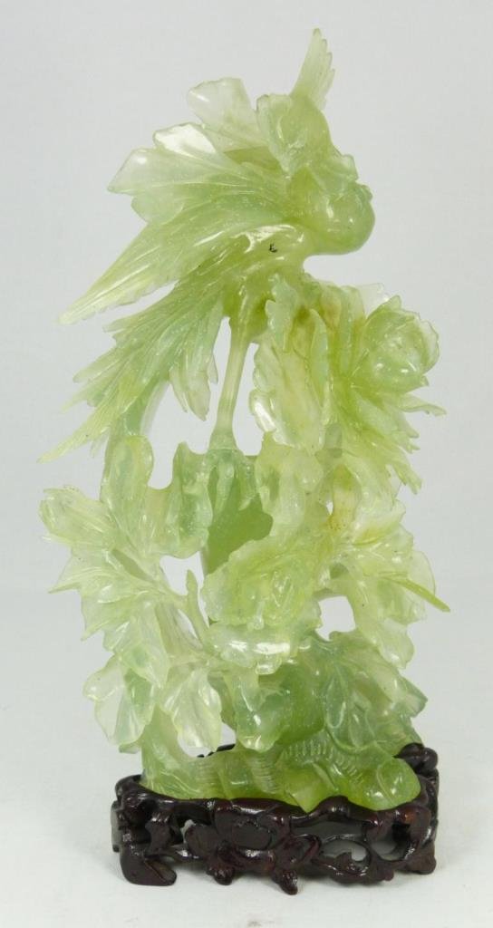 SERPINITINE JADE PHEONIX RELIEF CARVED SCULPTURE: Chinese carved serpentine jade item with spinach speckling. Has very well made wooden base with impressed 2989. 20th century. Measures 9 1/8" + 7/8" base (23.1 + 2.2). Total jade weight of 810 grams.