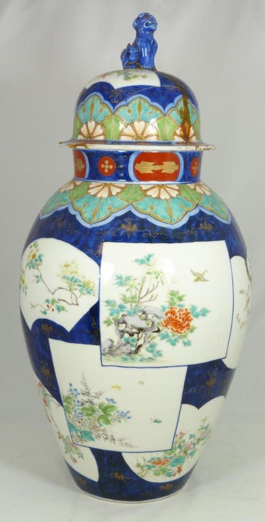 CHINESE PORCELAIN LIDDED IMARI VASE: Chinese hand painted Imari vase depicting floral scenes in fan shaped windows. Signed with red calligraphy to bottom. Late Meiji to Showa period. Measures 21" height x 10 1/2" diameter (53.3cm x 26.6c