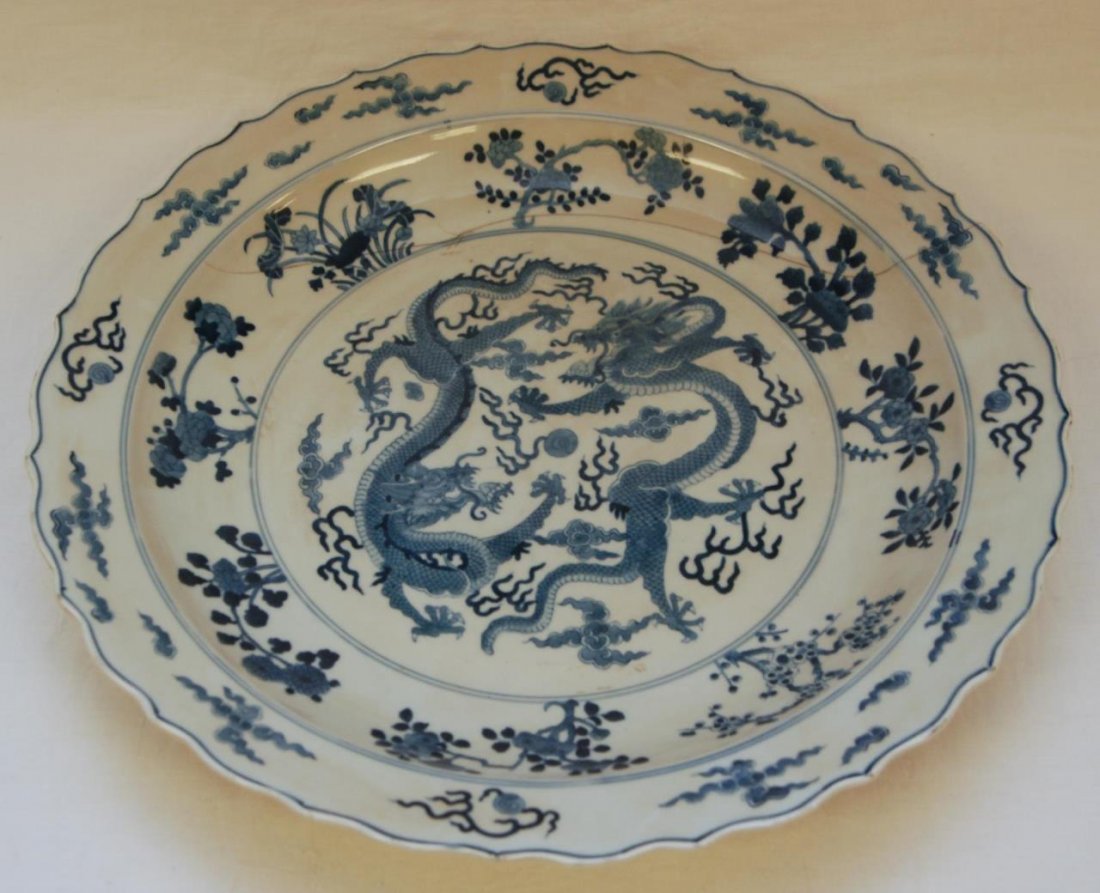 18th/19th C CHINESE BLUE & WHITE DRAGONS CHARGER: Antique Chinese hand painted blue and white porcelain charger depicting dual dragons to center with flaming pearl. Flowers, lingzhi form clouds and flaming pearls can be seen to scalloped rim. Bottom 